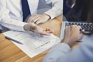 Business people negotiate for customers to sign land sales contracts photo