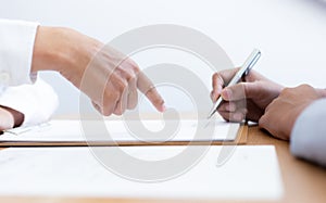 Business people negotiate for customers to sign land sales contracts photo