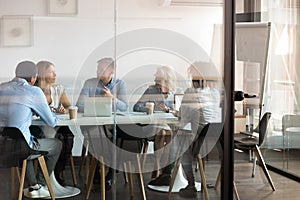 Business people negotiating at boardroom behind closed doors