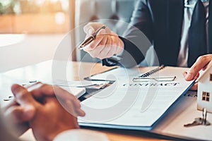 Business people negotiating a contract between two colleagues