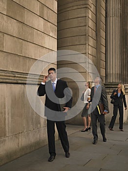 Business people outside monumental building