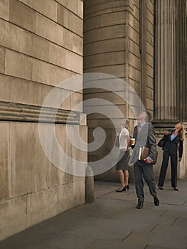Business people outside monumental building