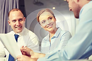 Business people with papers meeting in office