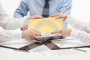 Business people passing an yellow envelope