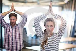 Business people performing yoga