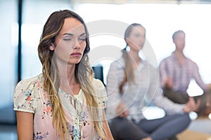 Business people performing yoga