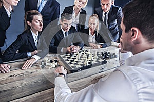 Business people playing chess