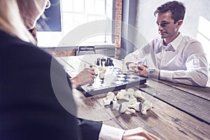 Business people playing chess