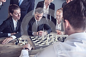 Business people playing chess