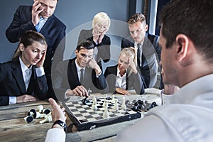 Business people playing chess