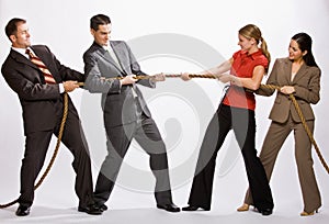 Business people playing tug-of-war