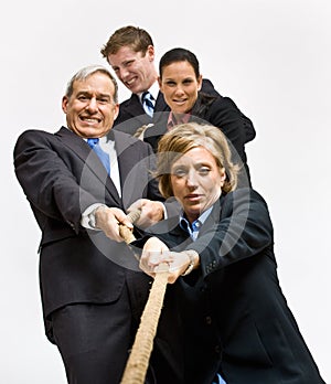 Business people playing tug-of-war