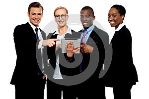 Business people pointing towards wireless tablet