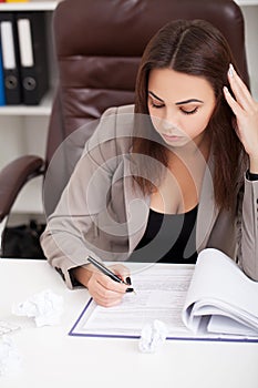 Business People. Portrait Of Woman In Office. Beautiful Confident Smiling Female Worker In Black Top and Gray Suit Sitting In