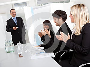 Business people at presentation applauding