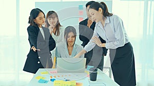 Business people proficiently discuss work project on computer