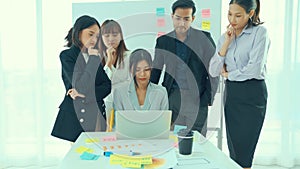 Business people proficiently discuss work project on computer