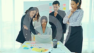 Business people proficiently discuss work project on computer