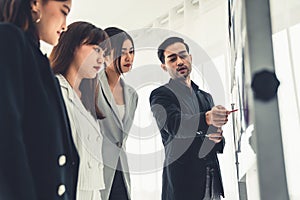 Business people proficiently discuss work project while sitting in circle