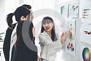 Business people proficiently discuss work project while sitting in circle