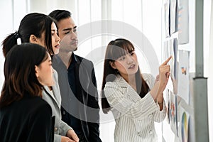 Business people proficiently discuss work project while sitting in circle