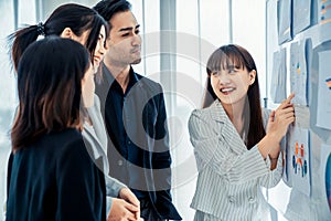 Business people proficiently discuss work project while sitting in circle