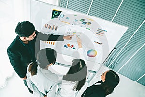 Business people proficiently discuss work project while sitting in circle