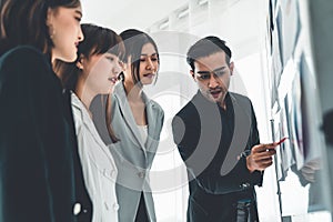 Business people proficiently discuss work project while sitting in circle