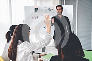 Business people proficiently discuss work project while sitting in circle