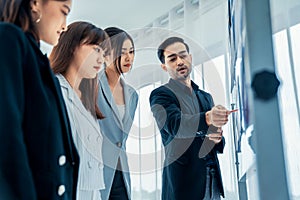 Business people proficiently discuss work project while sitting in circle