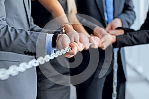 Business people pulling chain