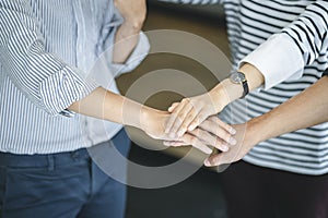 Business people put hands together. Team work and unity business concept