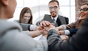 Business people putting their hands together