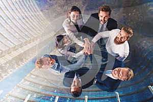 Business people putting their hands together. Concept of integration, teamwork and partnership. double exposure