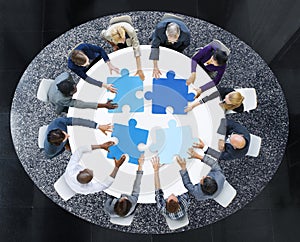 Business People with Puzzle Pieces and Teamwork Concept