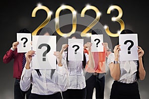 Business people with question mark and 2023 number