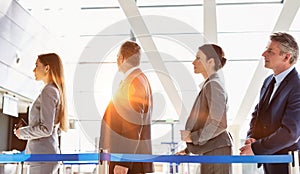 Business people queueing for check in at airport photo