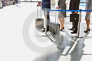 Business people queueing for check in airport photo