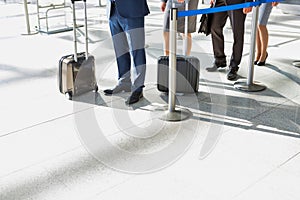 Business people queueing for check in airport photo