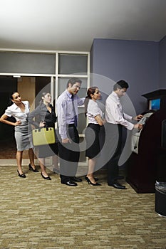 Business People Queuing At Vending Machine