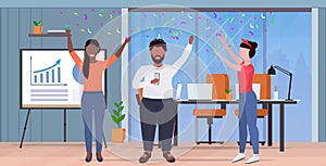 Business people raising arms colleagues having party confetti mix race coworkers celebrating event concept modern office