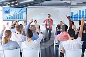 Business people raising their hands in a business conference
