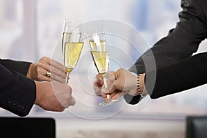 Business people raising toast with champagne