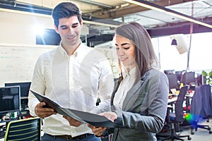 Business people reading a document together in the office.