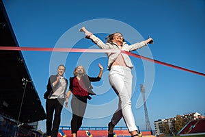 Business people running on racing track