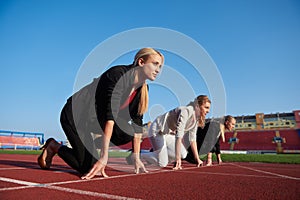 Business people running on racing track