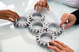 Business People`s Hand Connecting Gears