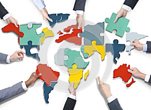Business People's Hands with Cartography Puzzle