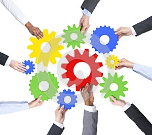 Business People s Hands Holding Cog