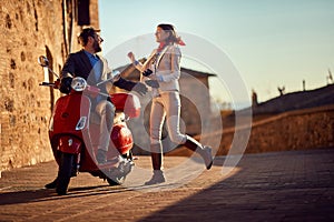 Business people on scooter..scooter in the city. Happy couple riding scooter